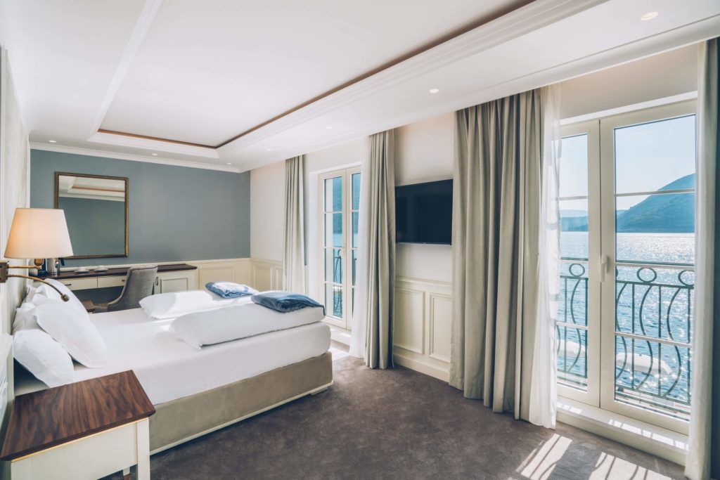 Hotel room with tall windows overlooking sea